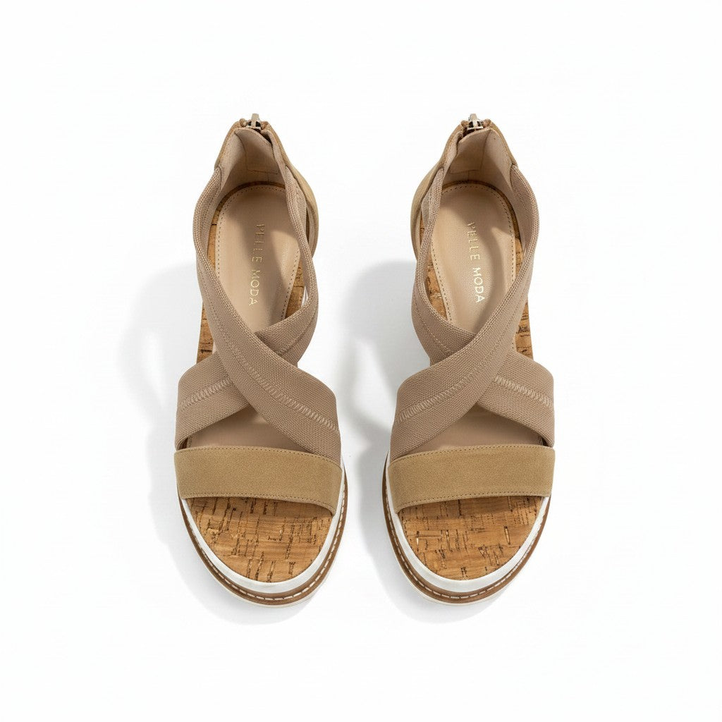 Pair of beige sandals with cork sole on a white background