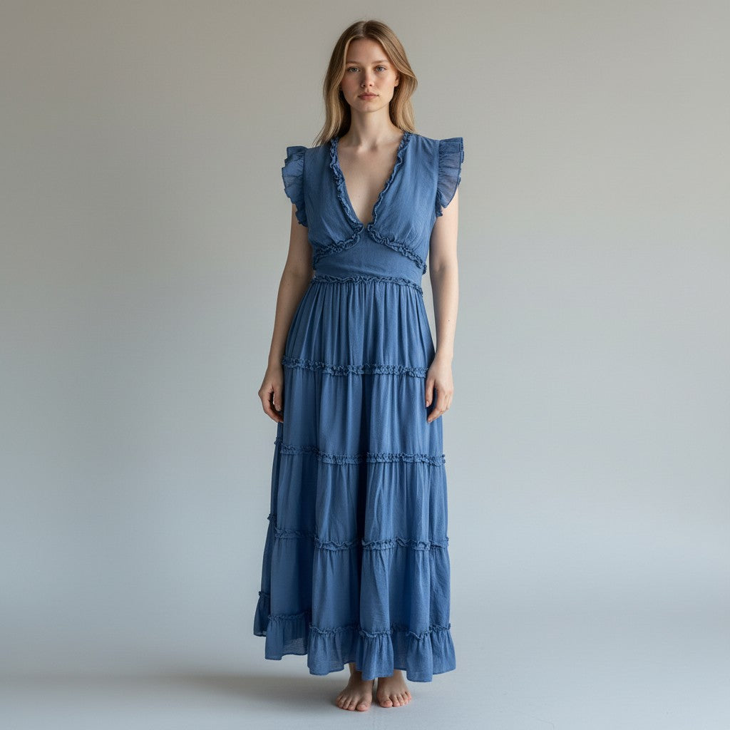 Woman wearing a blue dress against a plain background