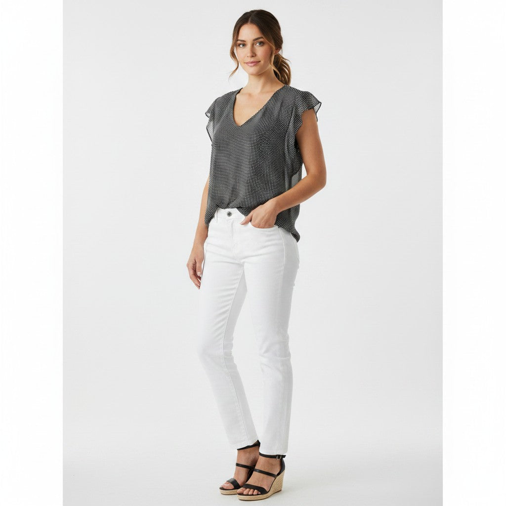 Woman wearing a gray blouse and white pants on a white background