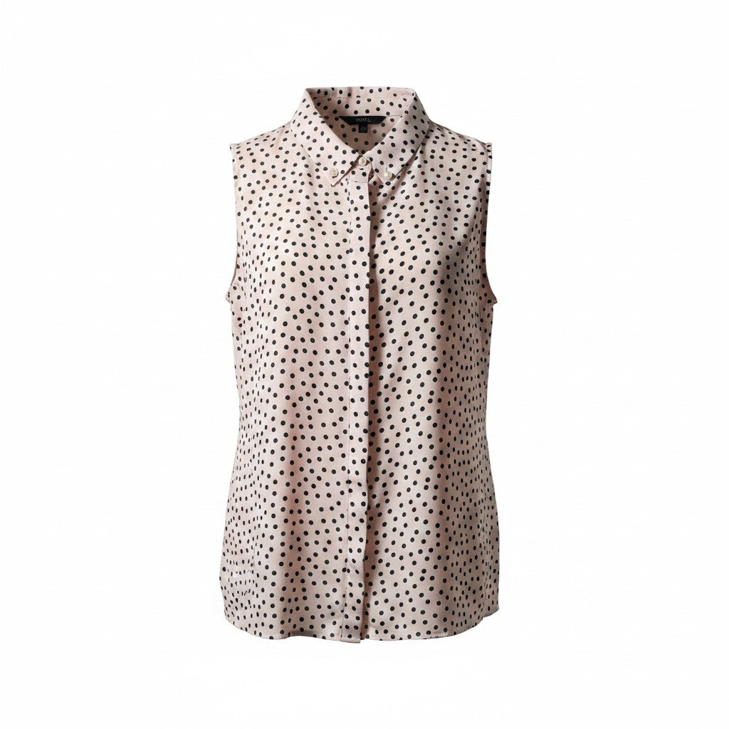 Sleeveless polka dot blouse on a white background