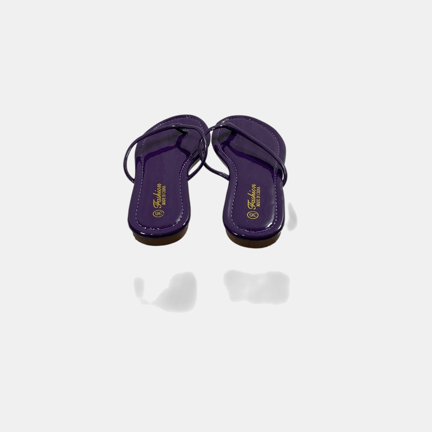 Pair of purple sandals on a white background