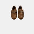 brown leather loafers with a horse bit on a white background