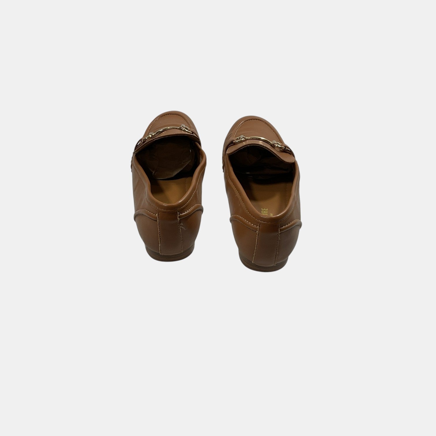 brown leather loafers with a horse bit on a white background