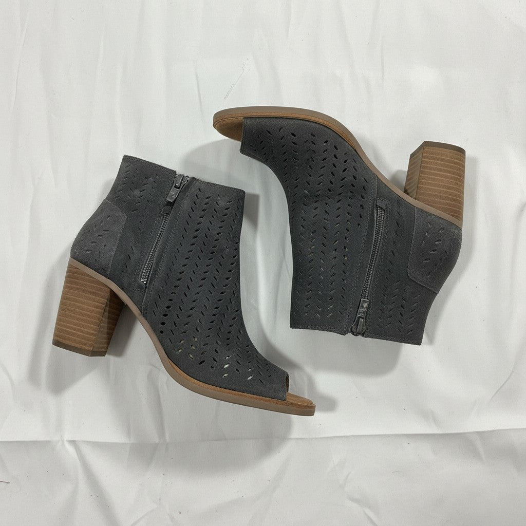 Pair of gray ankle boots with brown soles on a white background