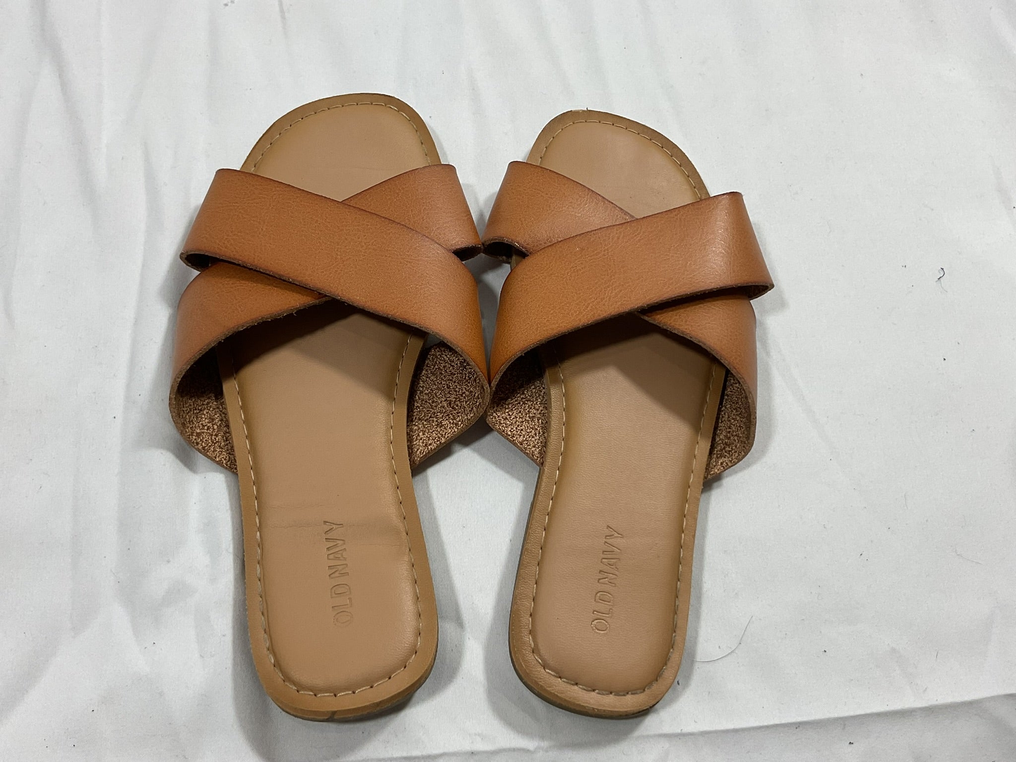 Pair of brown sandals on a white background