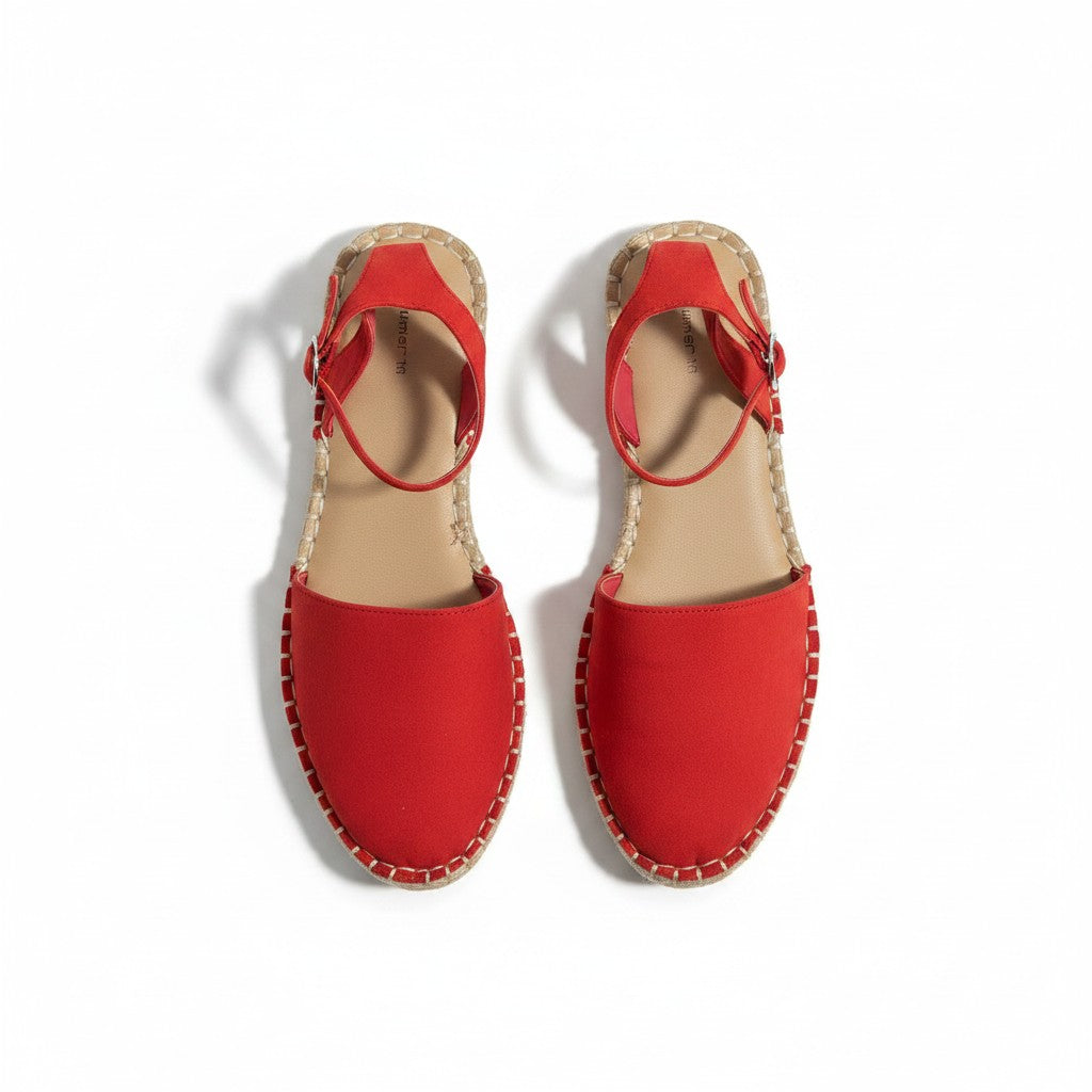Pair of red sandals with cork sole on a white background