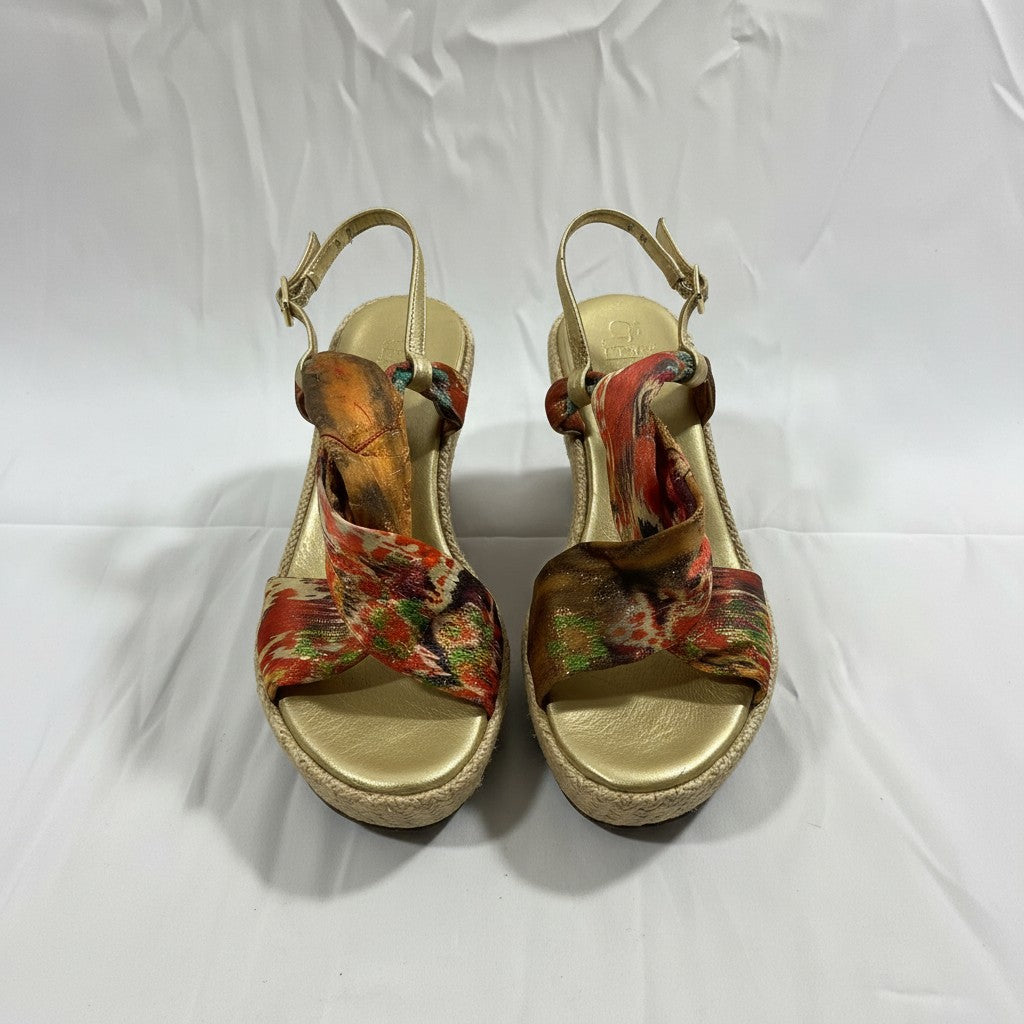 Pair of floral wedge sandals on a white background