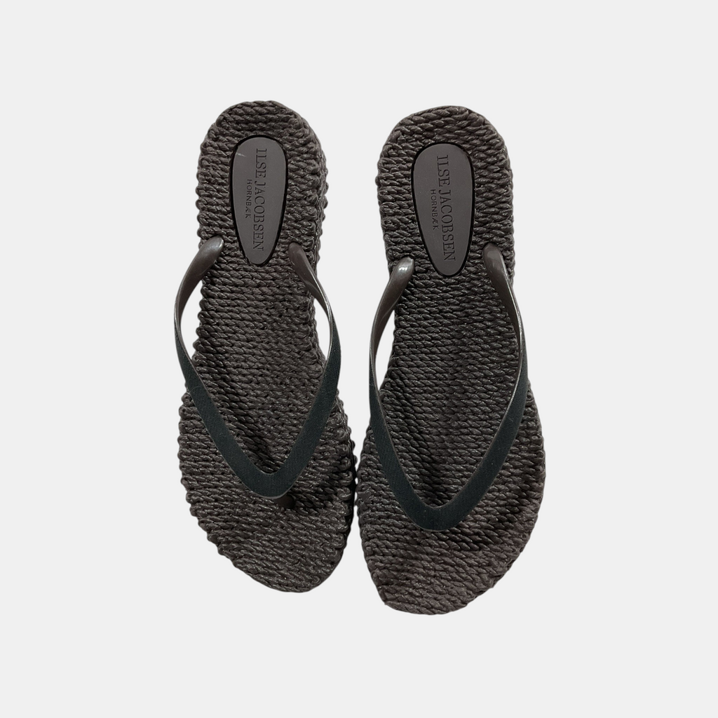 Pair of black woven sandals on a light gray background