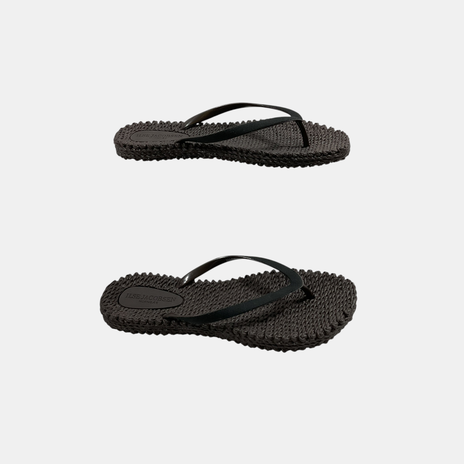 Black flip-flops on a light gray background