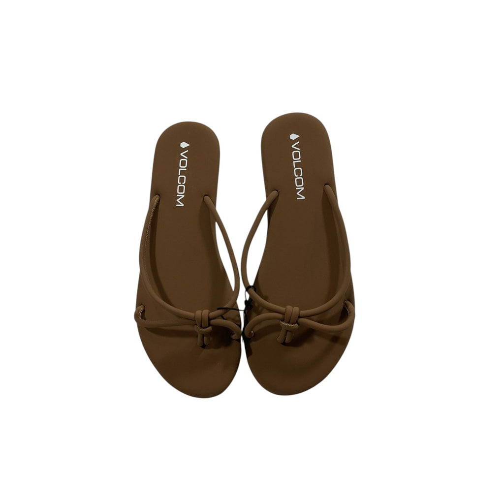 Brown sandals with 'Volcom' branding on a white background