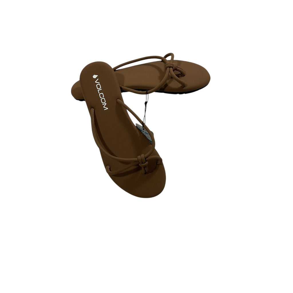 Brown sandals with 'Volcom' branding on a white background