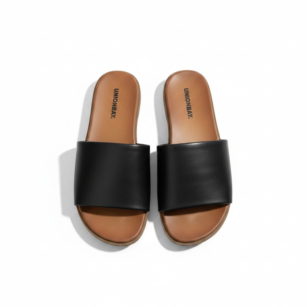 Black slide sandals with brown soles on a white background