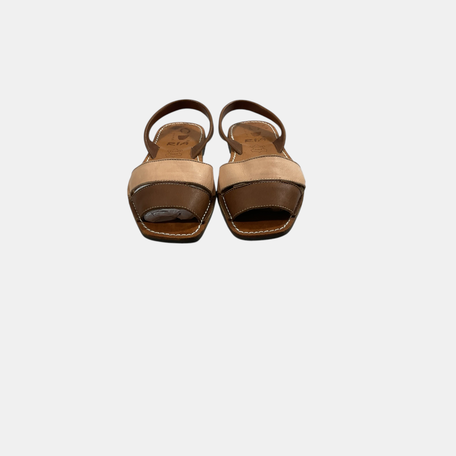 Pair of open-toe sandals with brown and beige color scheme on a white background