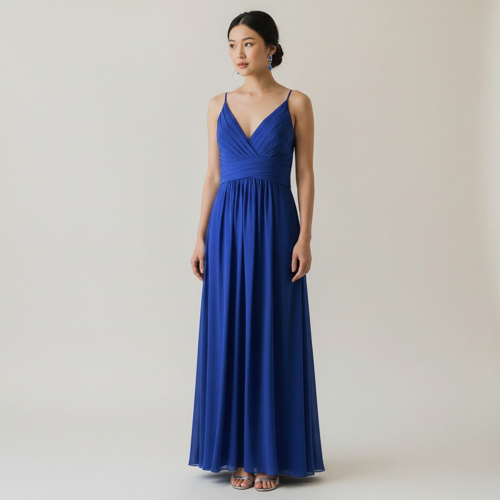 Woman wearing a blue dress against a plain background