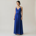 Woman wearing a blue dress against a plain background
