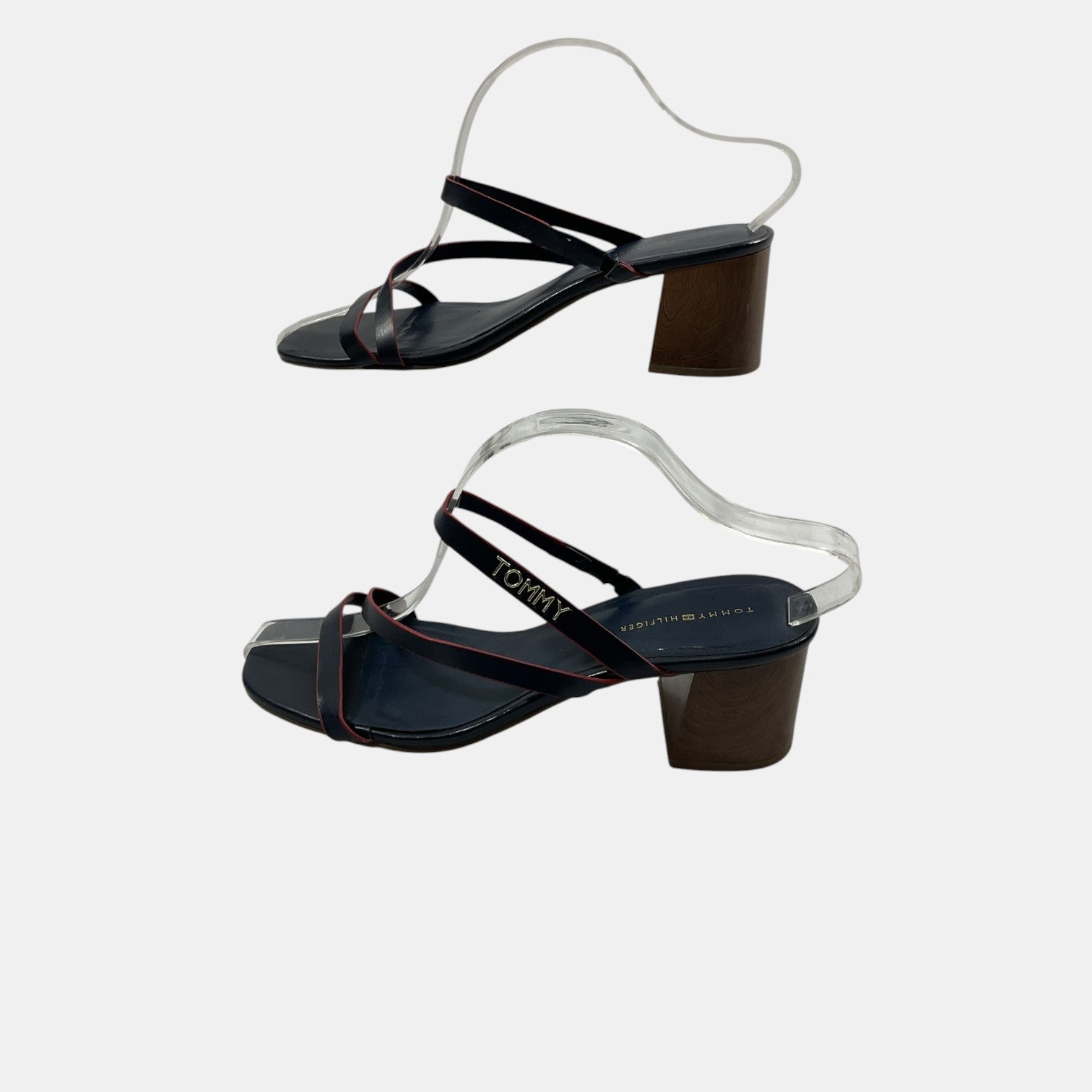 Black high-heeled sandals with transparent straps on a light gray background