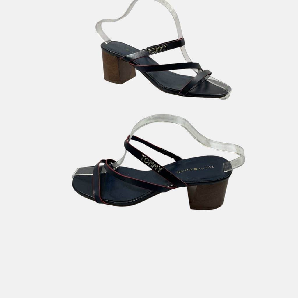 Black sandals with wooden heel and transparent strap on a white background