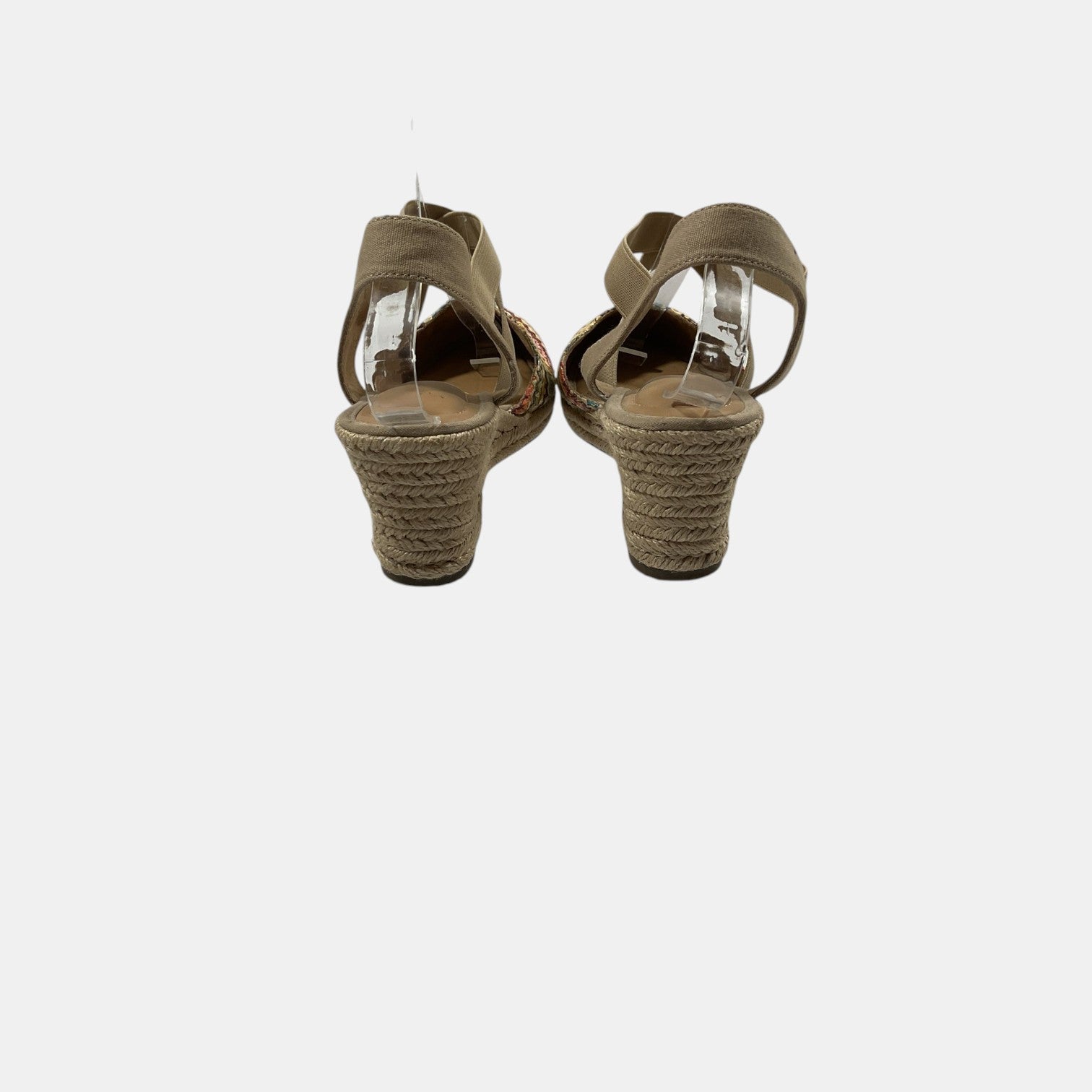 Pair of brown sandals with woven soles on a white background