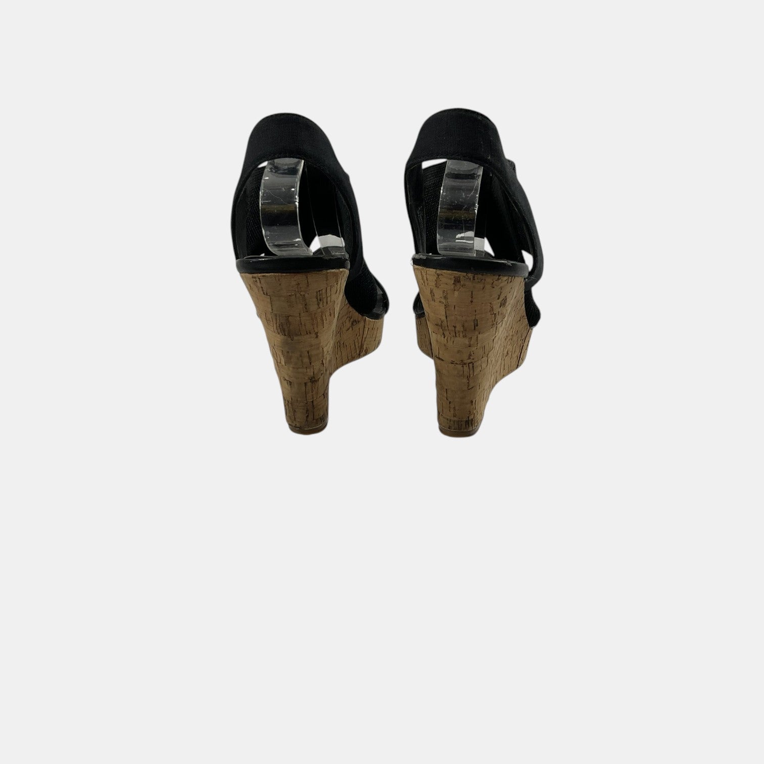 Black high-heeled shoes with cork soles on a white background