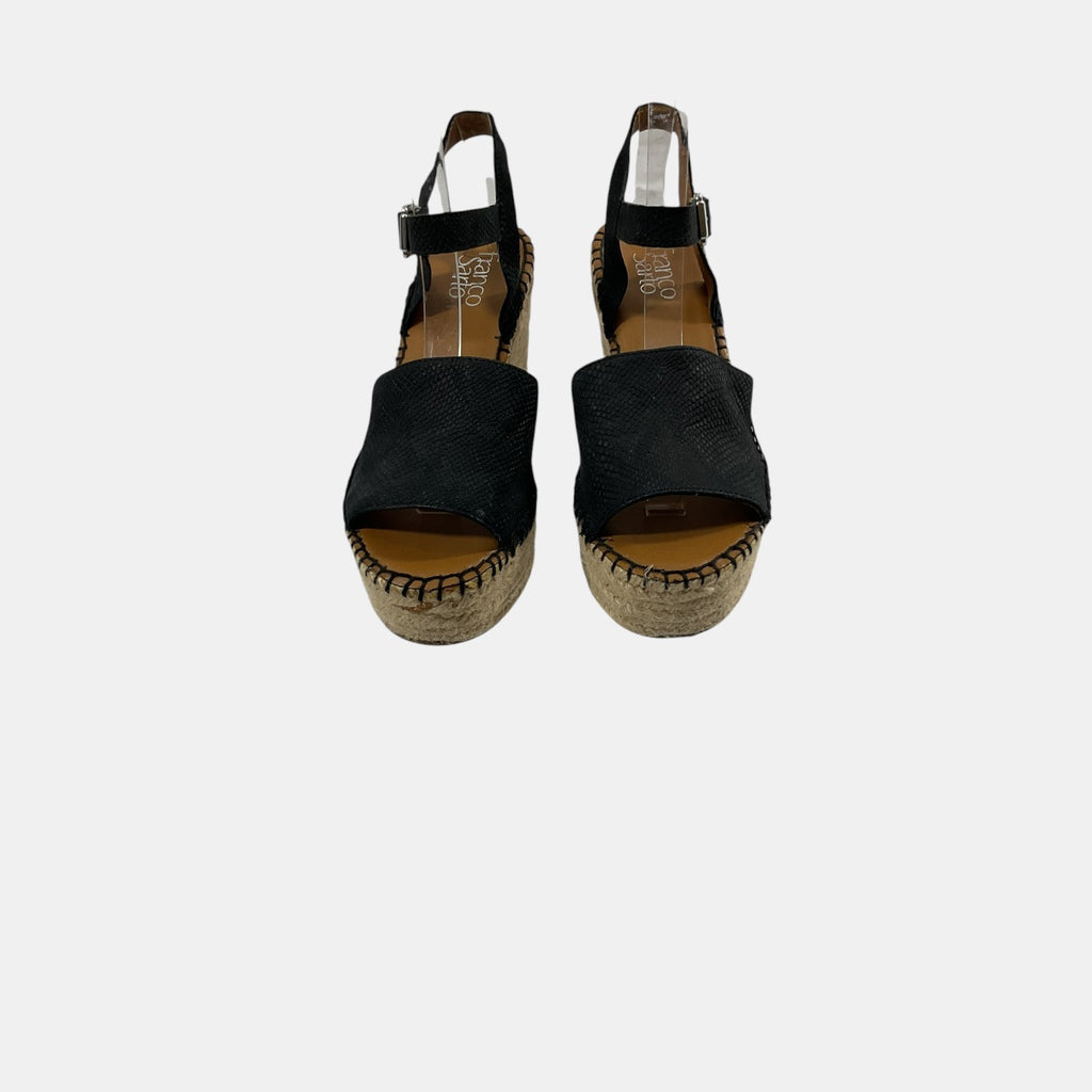 Pair of black espadrille sandals on a white background
