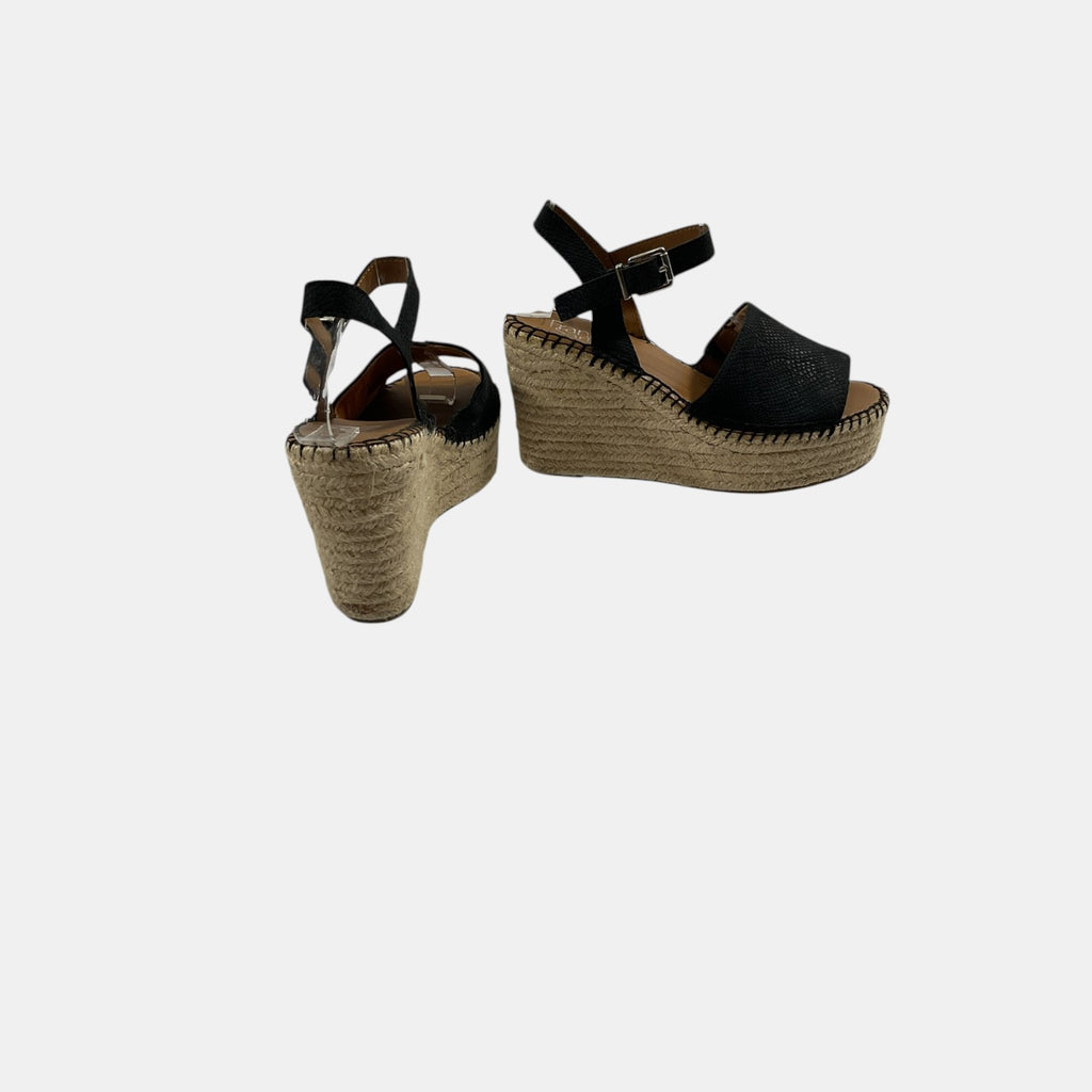 Pair of black wedge sandals with jute sole on a white background