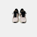 pink and black New Balance sneakers on a white background