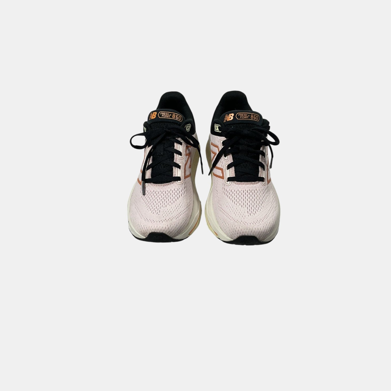 pink and black New Balance sneakers on a white background