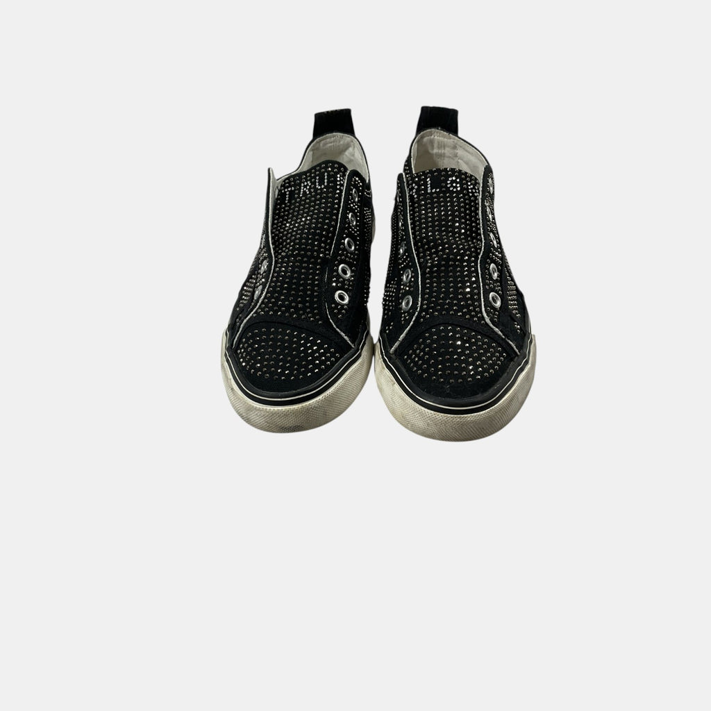 Black slip-on sneakers with rhinestone embellishments on a white background