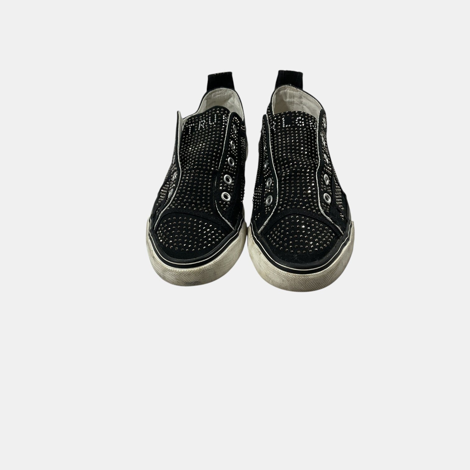 Black slip-on sneakers with rhinestone embellishments on a white background