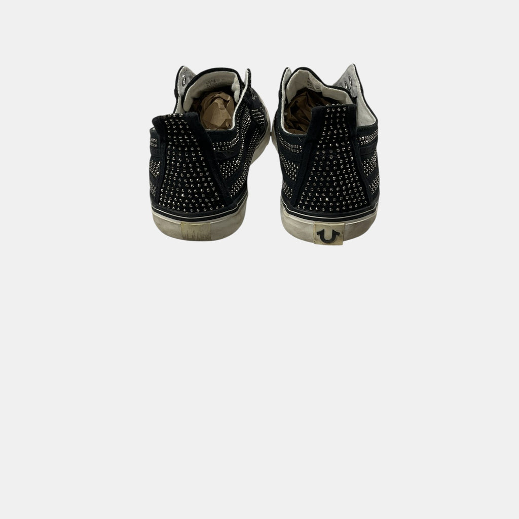 Black studded high-top sneakers on a white background