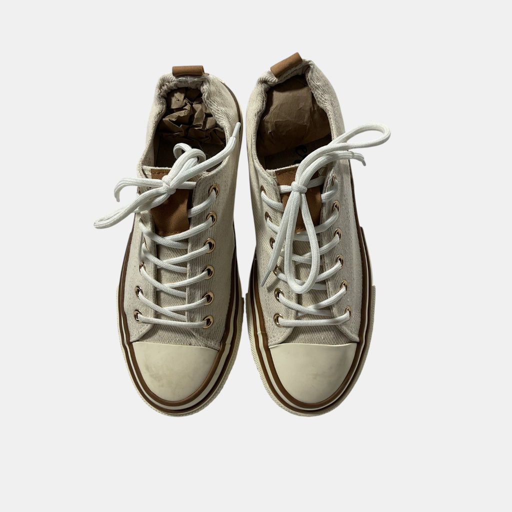 Pair of beige high-top sneakers with white laces on a light gray background