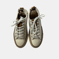 Pair of beige high-top sneakers with white laces on a light gray background