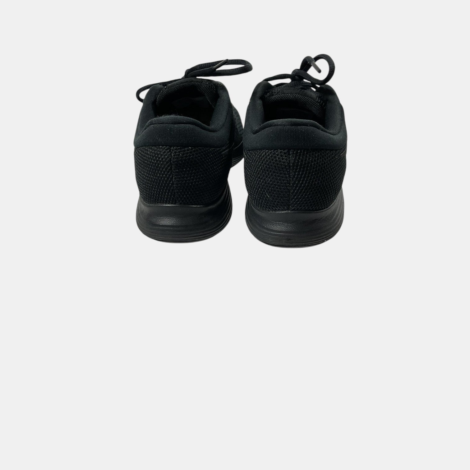 black Nike sneakers on a white background