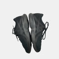 black Nike sneakers on a white background