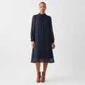 Woman wearing a navy blue dress on a white background