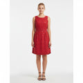 Woman wearing a red dress with a white background