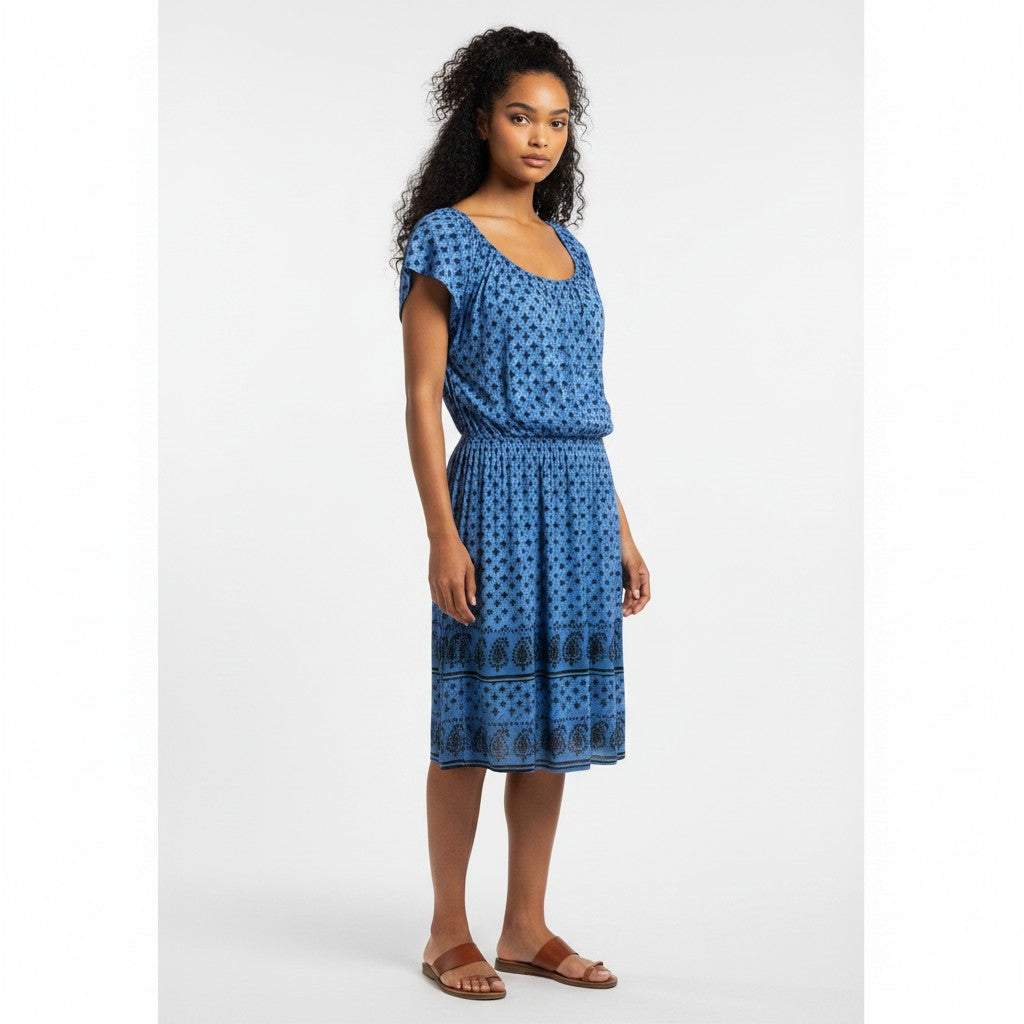 Woman wearing a blue patterned dress on a white background
