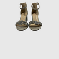 beige strappy high heels on a white background