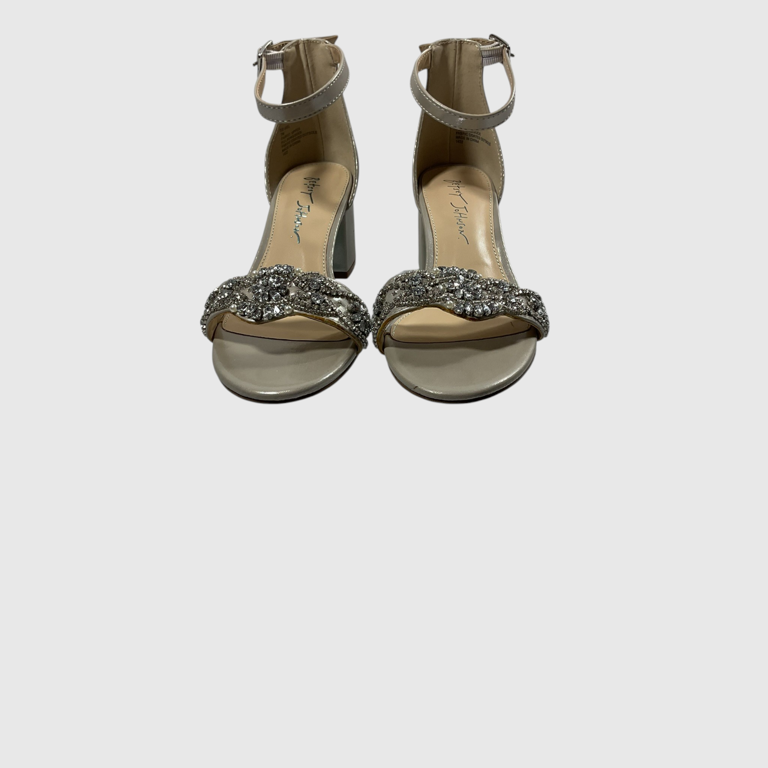 beige strappy high heels on a white background