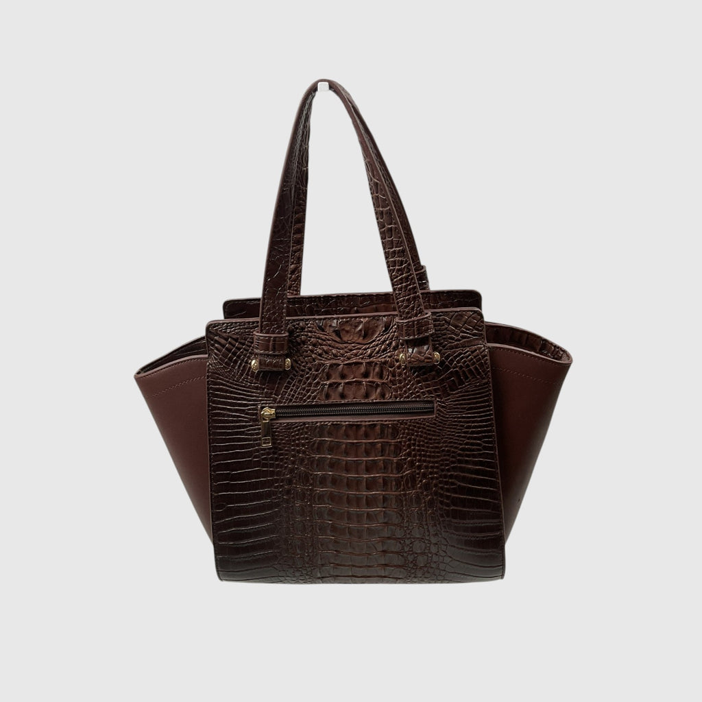 A dark brown handbag with a crocodile-embossed front panel and smooth brown side panels, featuring dual top handles and gold-tone hardware, set against a light gray background.