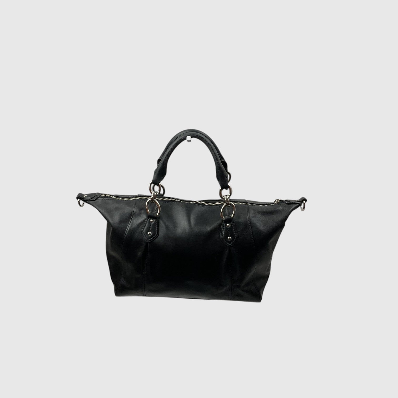 A black leather shoulder bag with dual top handles and gold-tone hardware, shown against a solid light gray background.