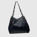 A Coach black pebbled leather hobo shoulder bag with silver-tone chain strap details and a small red leather hangtag, shown against a light gray background.