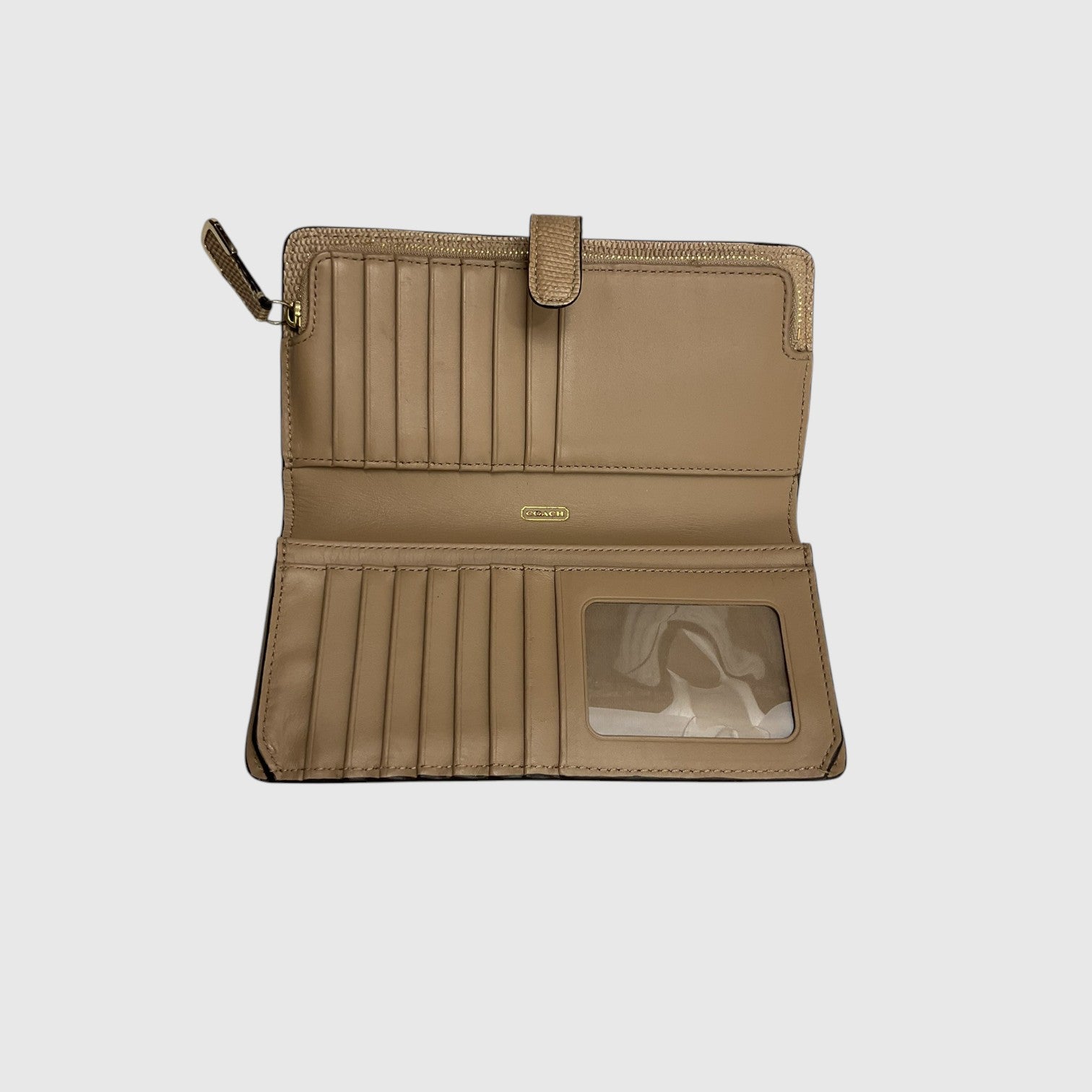 A tan leather wallet shown open against a light gray background, featuring multiple card slots, a vertical slip pocket, and a clear ID window.
