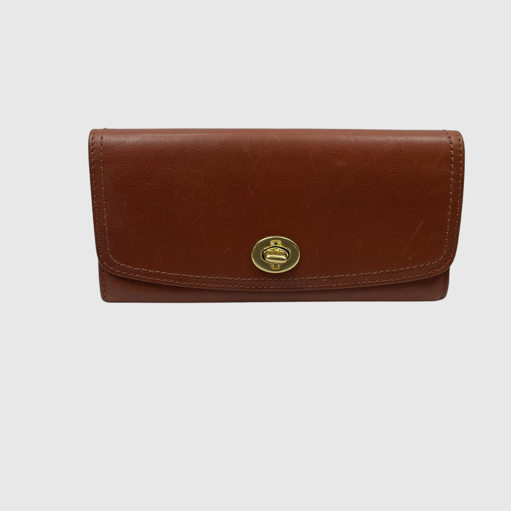 A brown leather clutch wallet with a gold-tone crown emblem on the front flap, set against a plain light gray background.