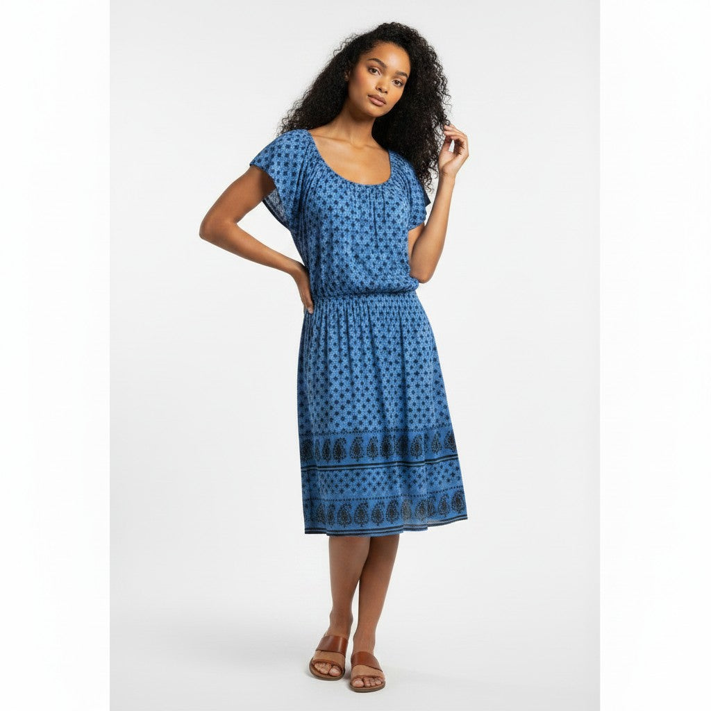Woman wearing a blue patterned dress on a white background