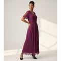 Woman wearing a purple lace dress against a white background
